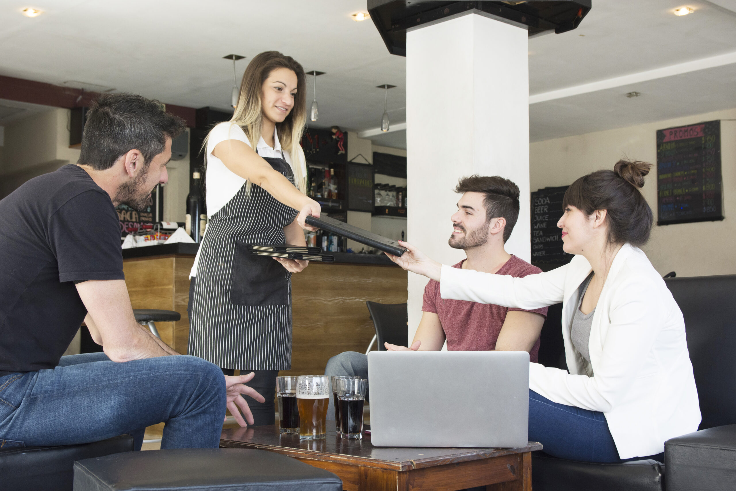 waitress-presenting-menu-female-customer-with-friends-bar